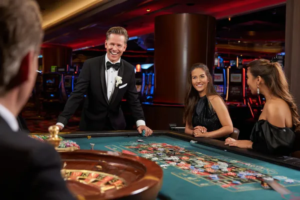 A close-up shot of golden coins falling around a spinning roulette wheel, representing immersive casino action at AH99.